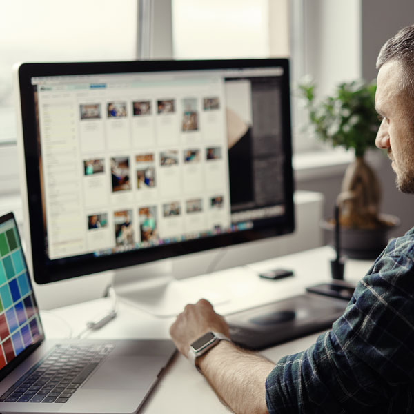 Man using computer to manage content Man using computer to manage content